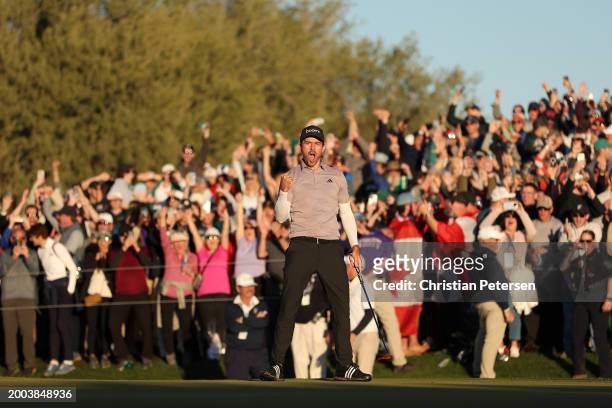 Nick Taylor of Canada celebrates making his putt on the 18th green to tie for the lead and force a playoff during the final round of the WM Phoenix...