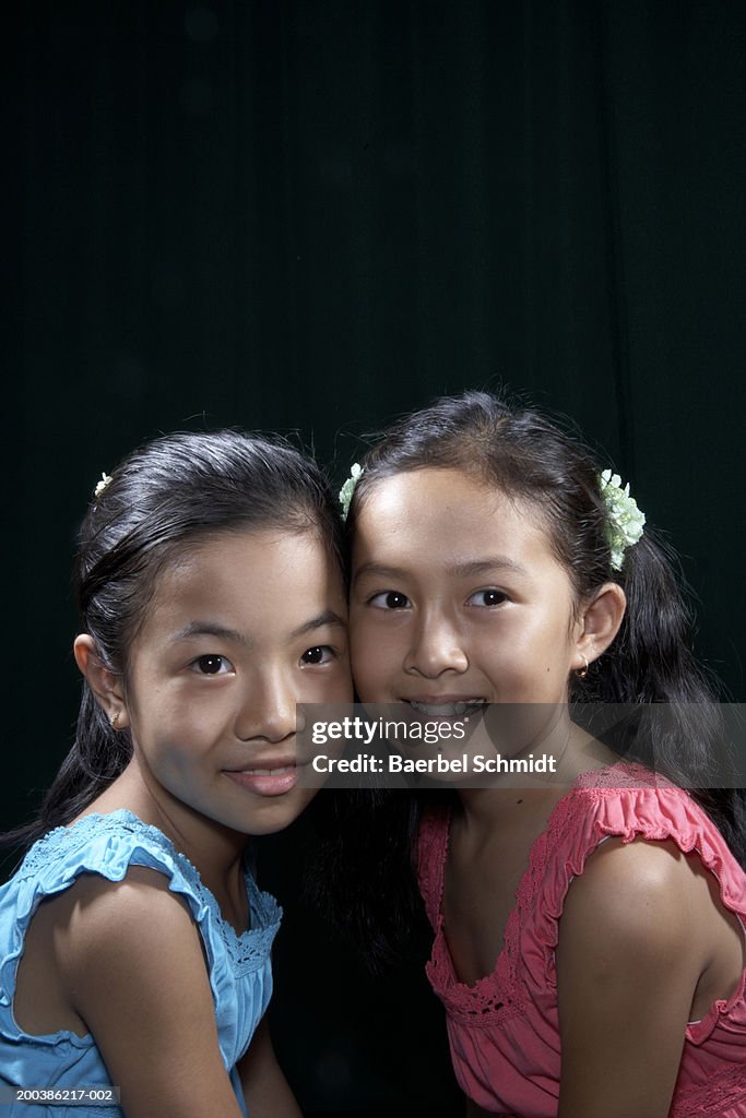 Two girls (8-10) smiling, portrait