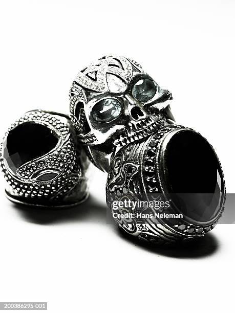 skull-shaped ring on top of two rings with black stone, close-up - ring shaped stock pictures, royalty-free photos & images