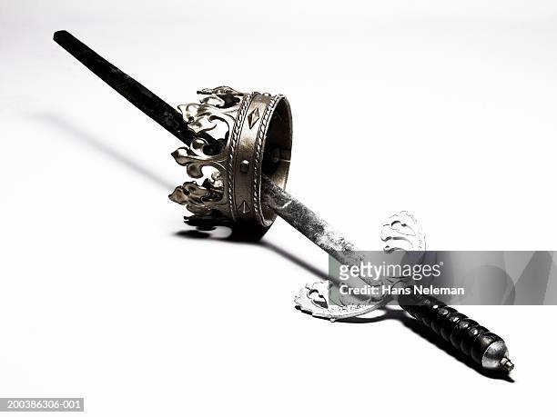 sword goring through crown-shaped ring, side view - royalty crown stock pictures, royalty-free photos & images