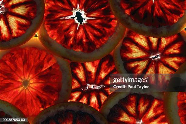 slices of blood orange - bloedsinaasappel stockfoto's en -beelden