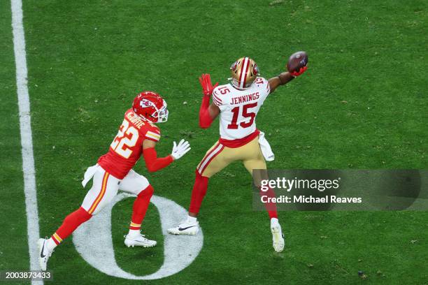 Jauan Jennings of the San Francisco 49ers throws the ball to Christian McCaffrey for a touchdown in the second quarter against the Kansas City Chiefs...