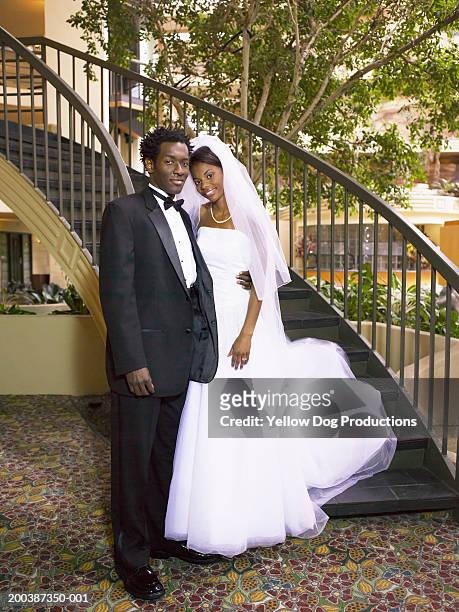 bride and groom by staircase, portrait - african american wedding foto e immagini stock