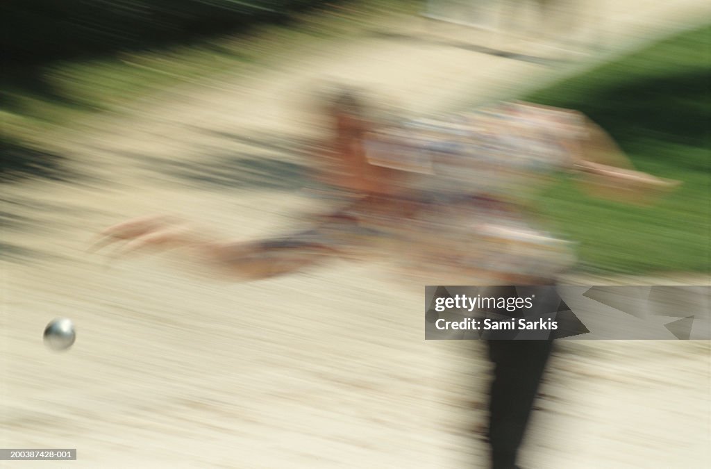 French boules player throwing boule (defocussed)