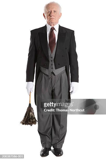 senior male butler holding feather duster, portrait - tail coat stock pictures, royalty-free photos & images