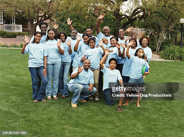 multi generational family waving at reunion - black family reunion stock-fotos und bilder