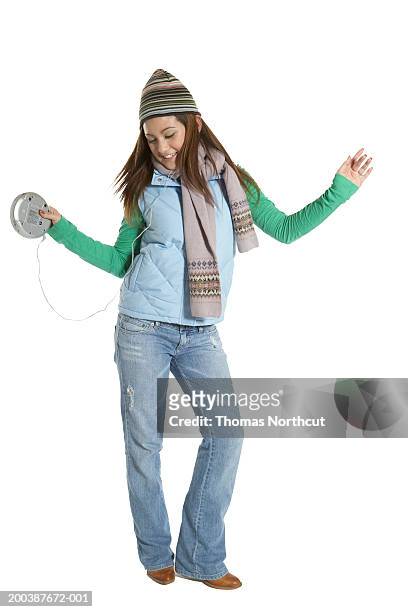 teenage girl (15-17) wearing headphones, dancing and smiling - personal compact disc player 個照片及圖片檔