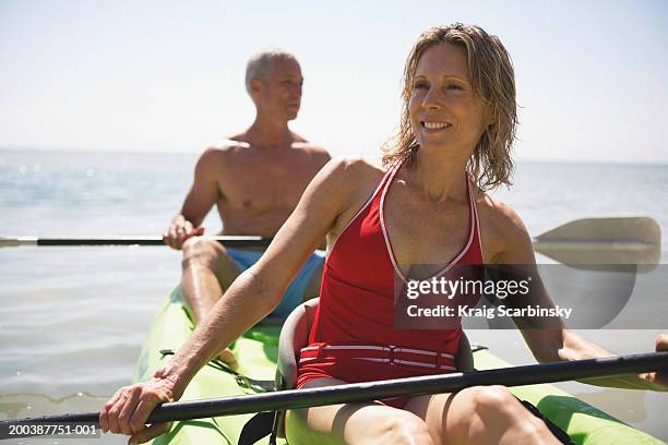 senior couple in kayak smiling, close-up (focus on woman) - senior water women stock-fotos und bilder