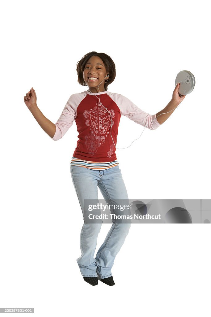 Teenage girl (15-17) listening to personal CD player, dancing