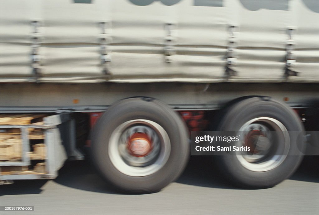 Truck driving on road, section (blurred motion)