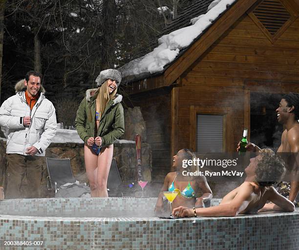 five young adults drinking alcohol and soaking in hot tub, winter - hot tub party stock pictures, royalty-free photos & images