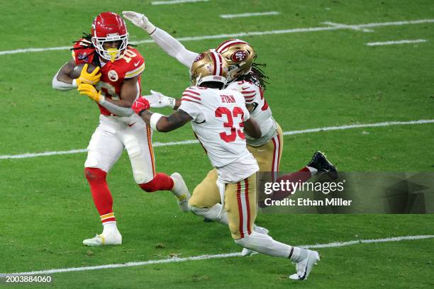 Fred Warner and Logan Ryan of the San Francisco 49ers attempt to tackle Isiah Pacheco of the Kansas City Chiefs in the second quarter during Super...