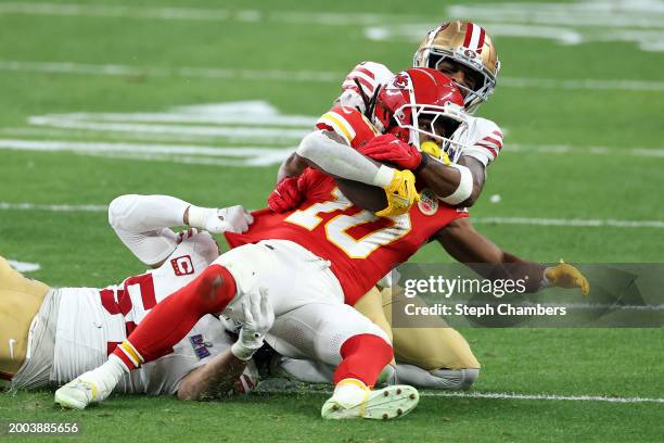 Fred Warner and Logan Ryan of the San Francisco 49ers tackle Isiah Pacheco of the Kansas City Chiefs in the second quarter during Super Bowl LVIII at...