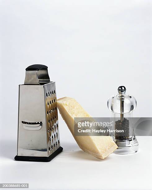 parmesan cheese, grater and pepper mill - reiben stock-fotos und bilder