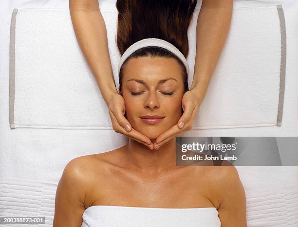 young woman receiving facial, eyes closed, overhead view - spa treatment stock pictures, royalty-free photos & images