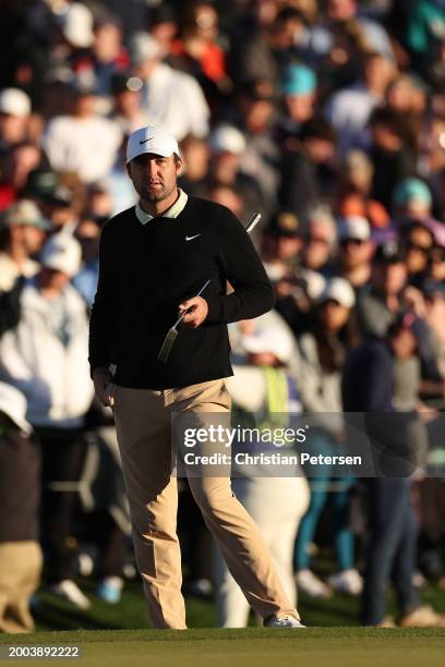 Scottie Scheffler of the United States looks on from the 18th green during the final round of the WM Phoenix Open at TPC Scottsdale on February 11,...