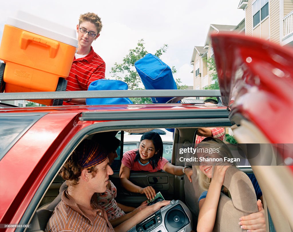 Young people packing car for roadtrip
