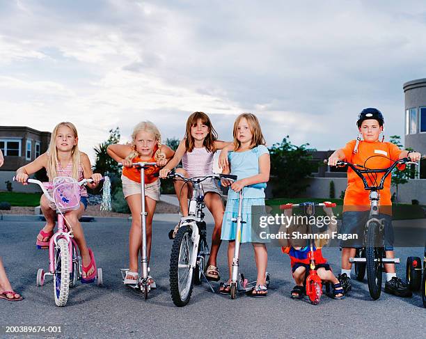 children (3-11) on bicycles and scooters in street, portrait - cul de sac stock-fotos und bilder