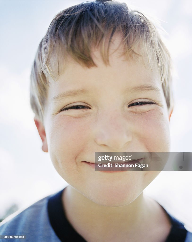 Boy (6-8) smiling, portrait