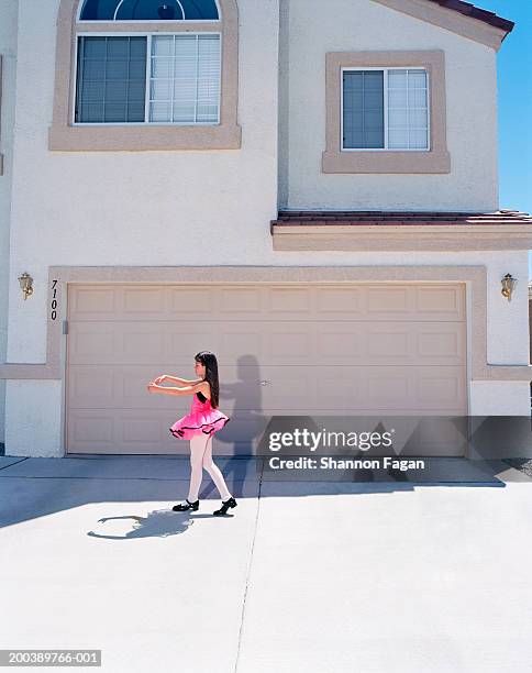 girl (7-9) practicing ballet in driveway, side view - girls tights stock pictures, royalty-free photos & images