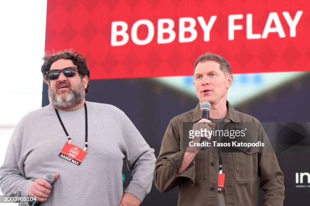 Aaron May and Bobby Flay speak onstage during The Players Tailgate hosted by Bobby Flay presented by Bullseye Event Group for Super 58 on February...