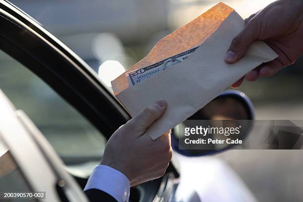 money being handed over from car, close-up - scheme stock pictures, royalty-free photos & images