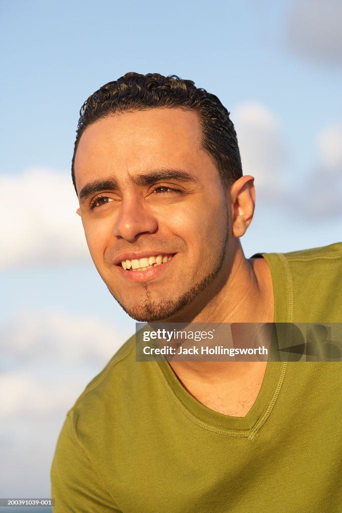 Close-up of a young man looking away smiling