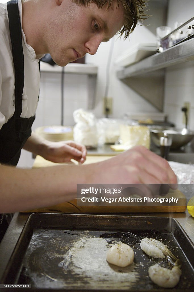 Chef preparing appetizer in kitchen, close-up