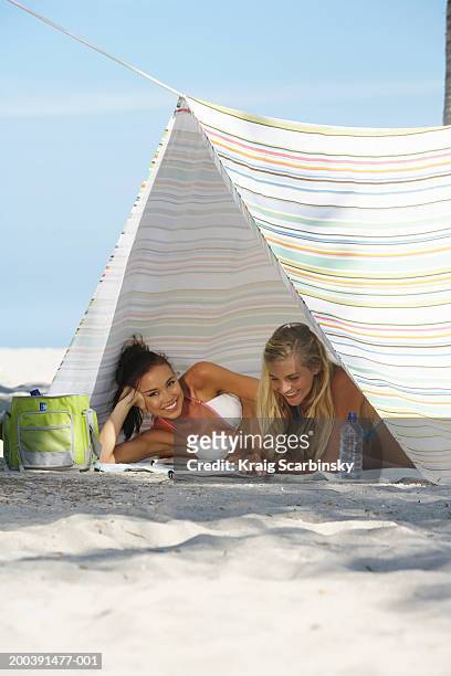 two young women smiling in tent on beach, portrait - magazine retreat day 2 stock pictures, royalty-free photos & images