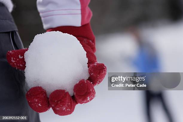 woman holding a snowball, mid section, close-up - 雪玉 ストックフォトと画像