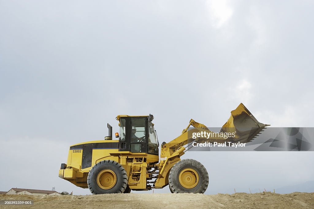 Construction worker in cab of bulldozer