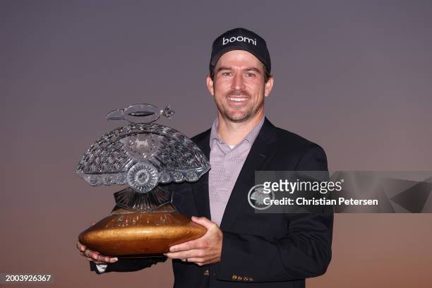 Nick Taylor of Canada celebrates with the trophy after winning in a two-hole playoff during the final round of the WM Phoenix Open at TPC Scottsdale...