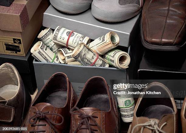 shoe box filled with roles of us notes - shoe boxes stock pictures, royalty-free photos & images