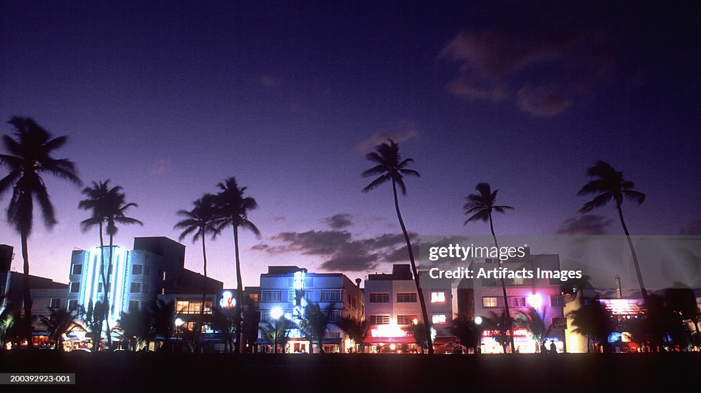 Buildings with lights at sunset