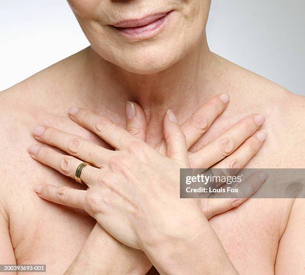 senior woman with hands crossed on chest, close-up - crossed bildbanksfoton och bilder