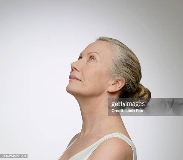 senior woman looking up, side view - senior spirituality stock pictures, royalty-free photos & images