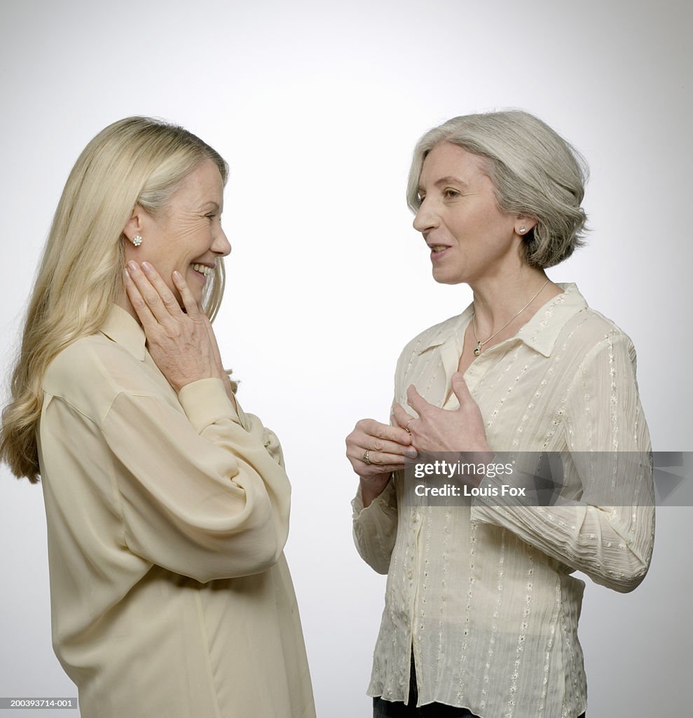 Senior woman and mature woman talking, side view