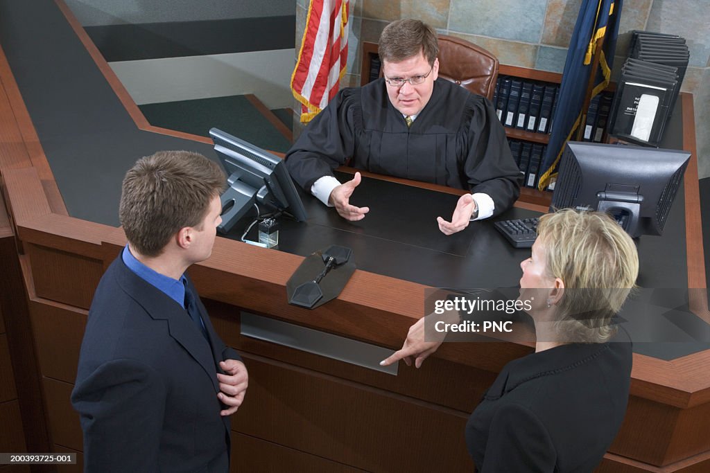 Two lawyers talking with judge, elevated view