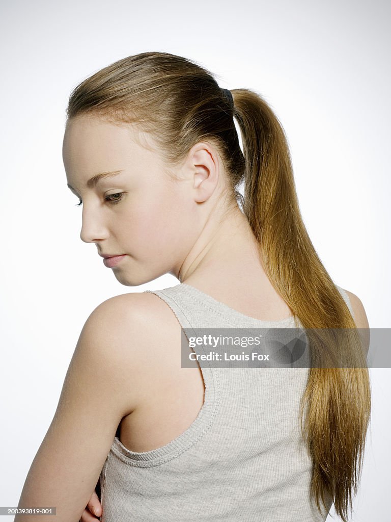 Teenage girl (14-16) looking over shoulder