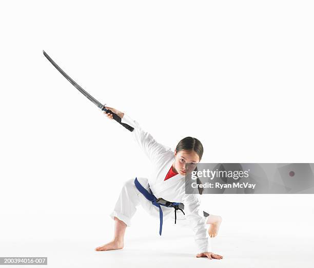 girl (8-10) with sword, holding kempo karate pose - karate girl stock pictures, royalty-free photos & images