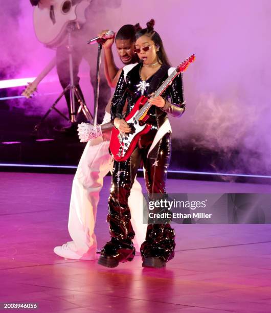 Usher and H.E.R. Perform onstage during the Apple Music Super Bowl LVIII Halftime Show at Allegiant Stadium on February 11, 2024 in Las Vegas, Nevada.