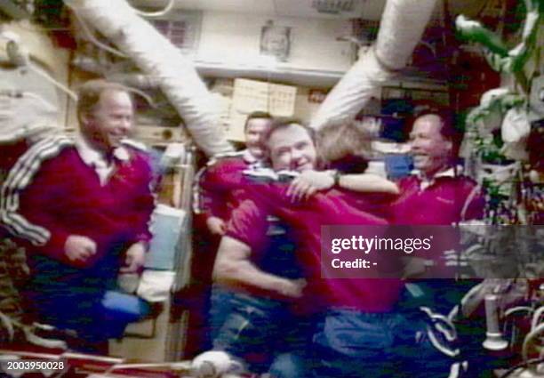 Russian MIR-18 Flight Engineer Gennadiy Strekalov embraces US Space Shuttle Atlantis Mission Specialist Bonnie Dunbar 29 June in the core module of...