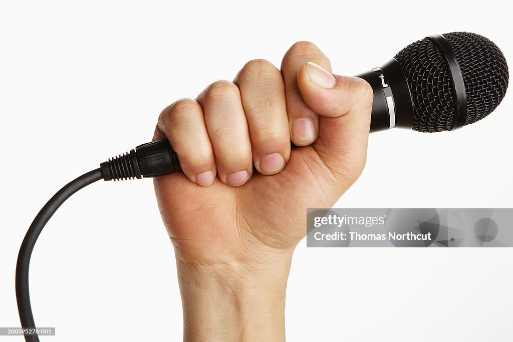 Man holding microphone (focus on microphone)