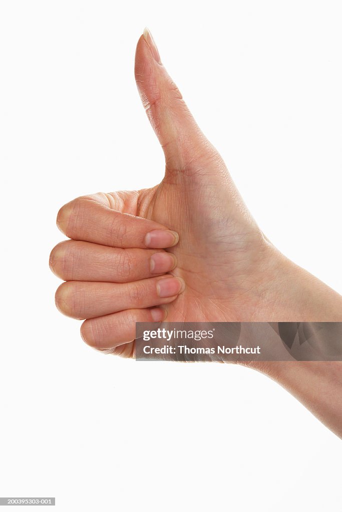 Woman giving thumbs up (focus on hand)