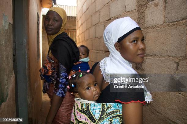 Local African women are seen carrying their babies on their backs using the traditional method called 'porter bebe' in Yaounde, the capital of...