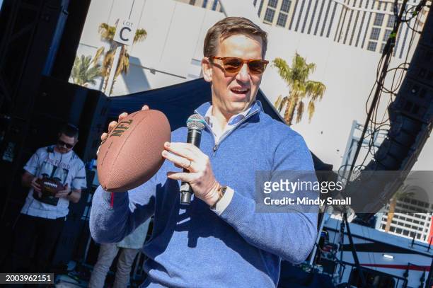 Eli Manning gets ready to throw a football into crowd at Guy Fieri's Flavortown Tailgate on February 11, 2024 in Las Vegas, Nevada.