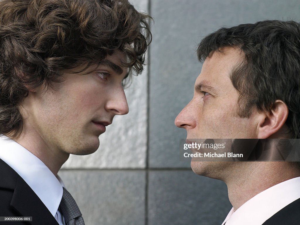 Two businessmen face to face, profile, close-up
