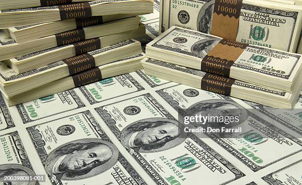 stacks and sheet of us one hundred dollar bills, elevated view - 100 dollar bills stock-fotos und bilder