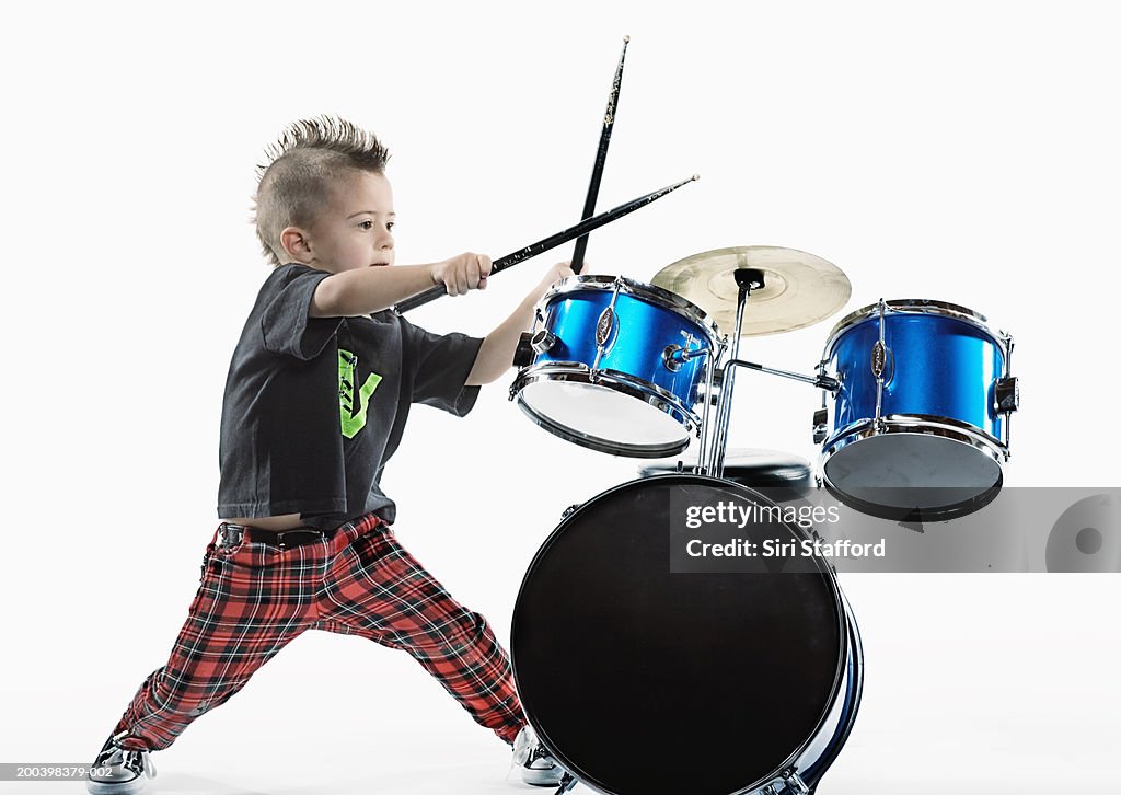 Boy (4-6) playing drums