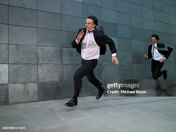 two businessmen running against wind - spåra bildbanksfoton och bilder